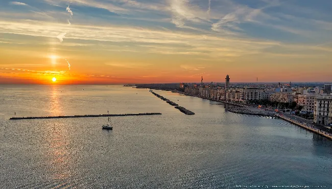 Sunrise over Bari from above: breakwaters and seafront