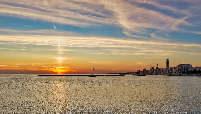 Sailing boat and rising sun over the Adriatic, Bari