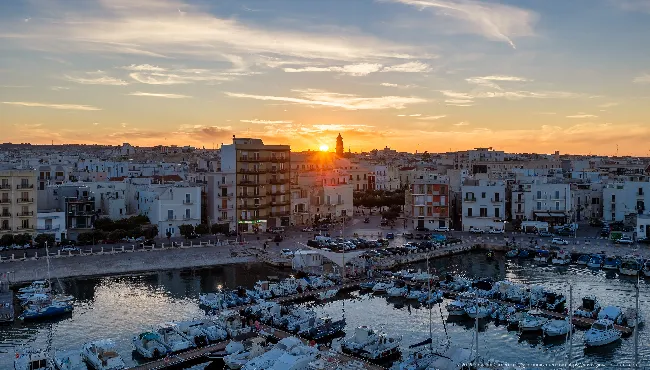 Sunset over Mola di Bari harbour: boats and pontoons