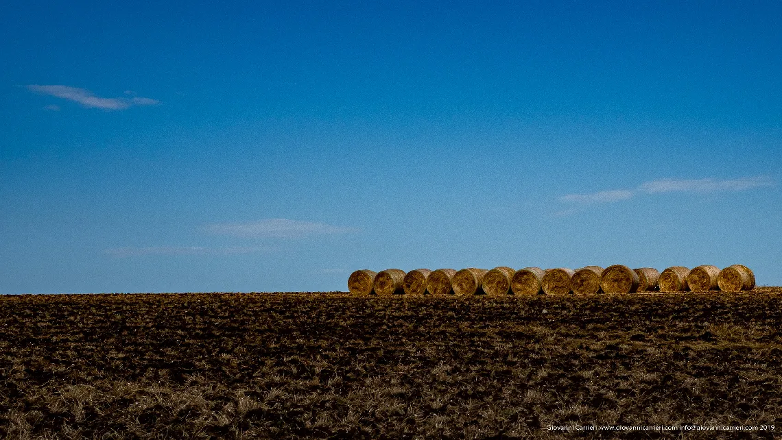 Hay bales and ploughed soil