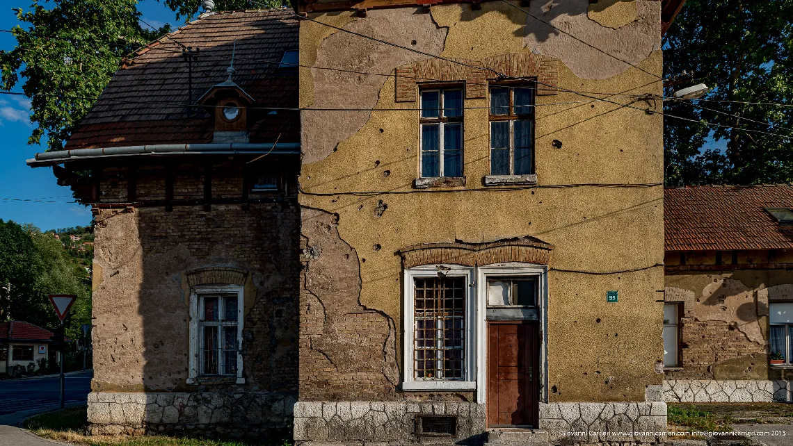 Tourists between signs of war in Mostar