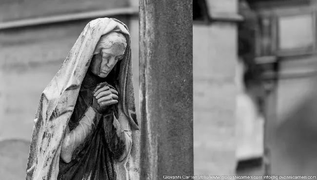 Monumental sculpture of woman in prayer