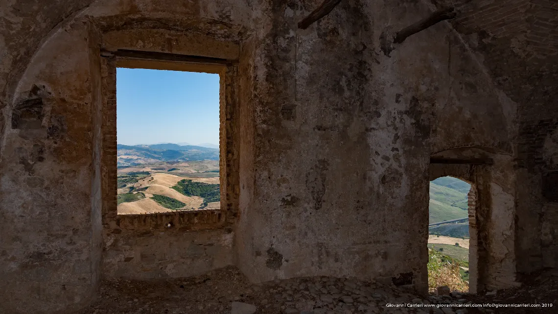 The windows of an abandoned house in old Craco
