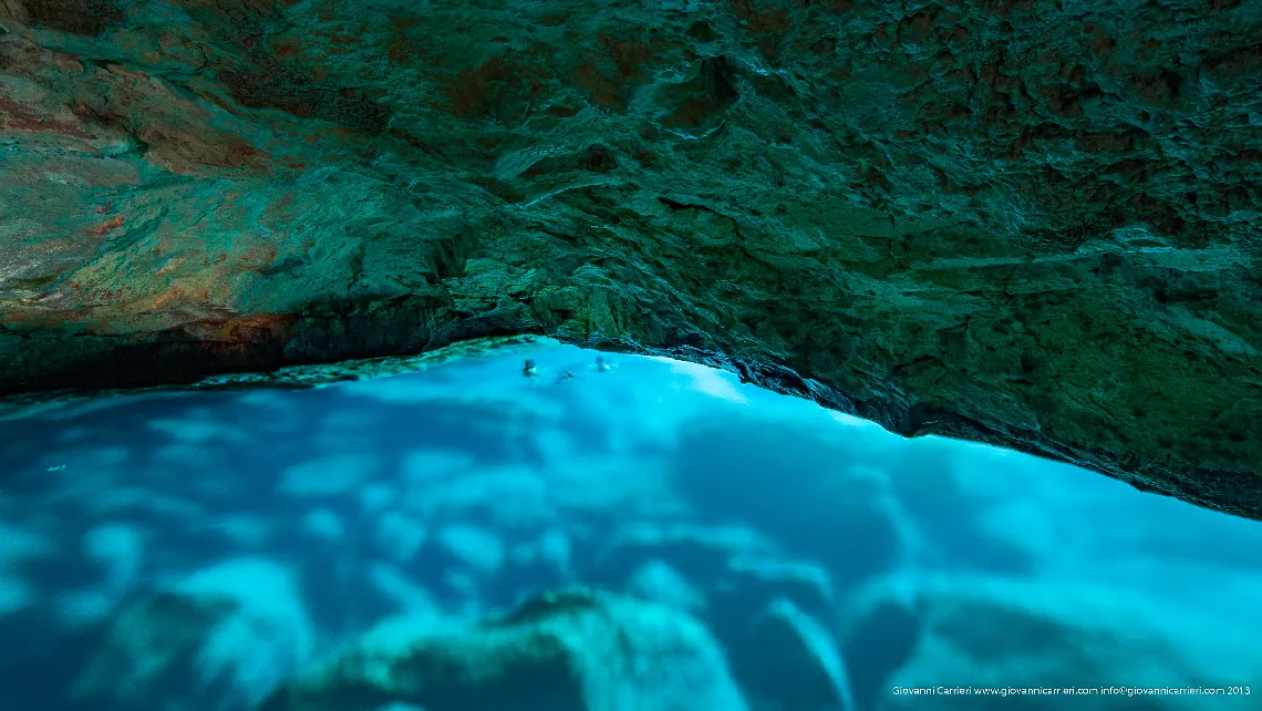 The transparent blue water of the green grotto