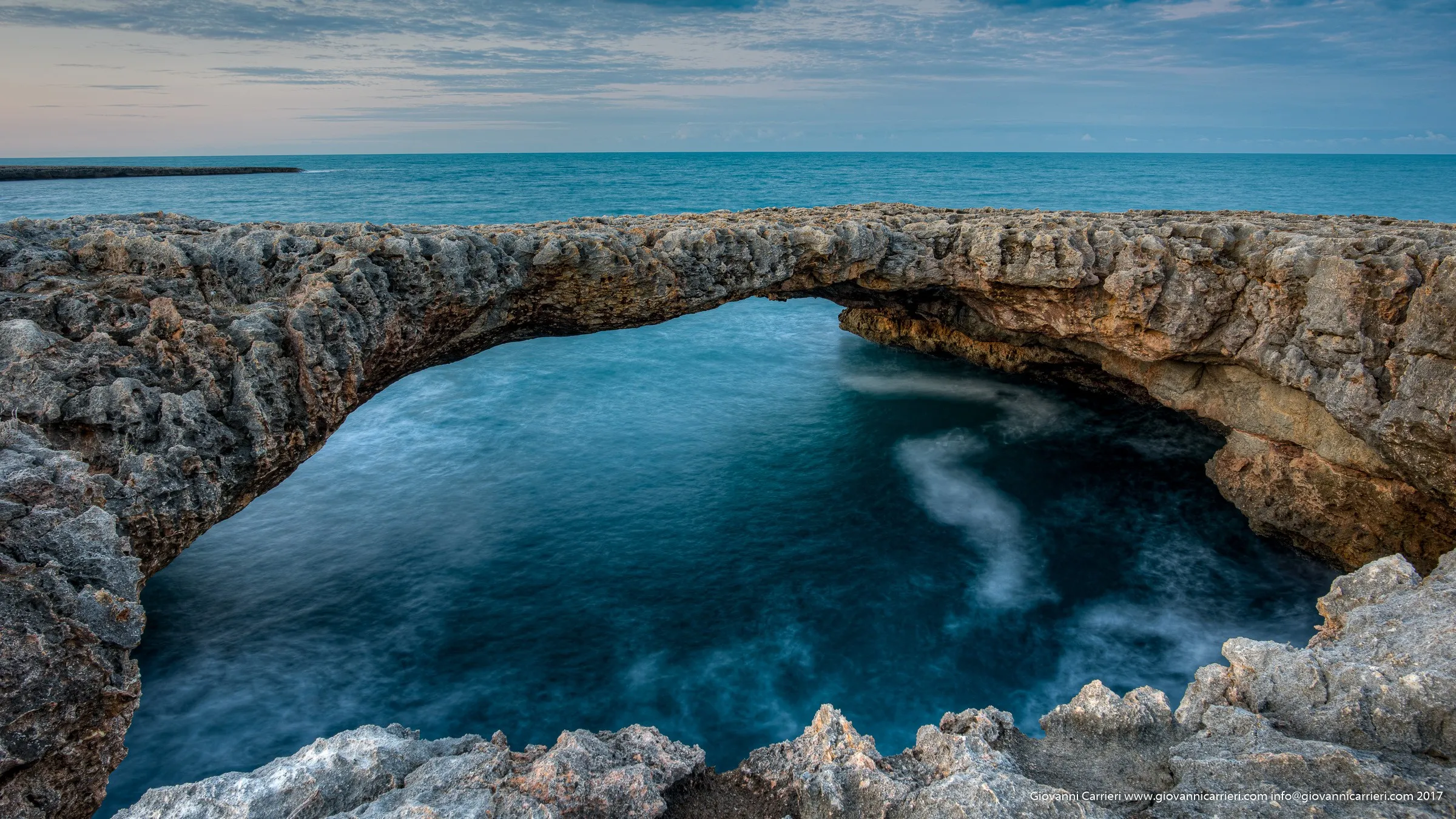 The natural bridge of Sella Grotto in Polignano a Mare
