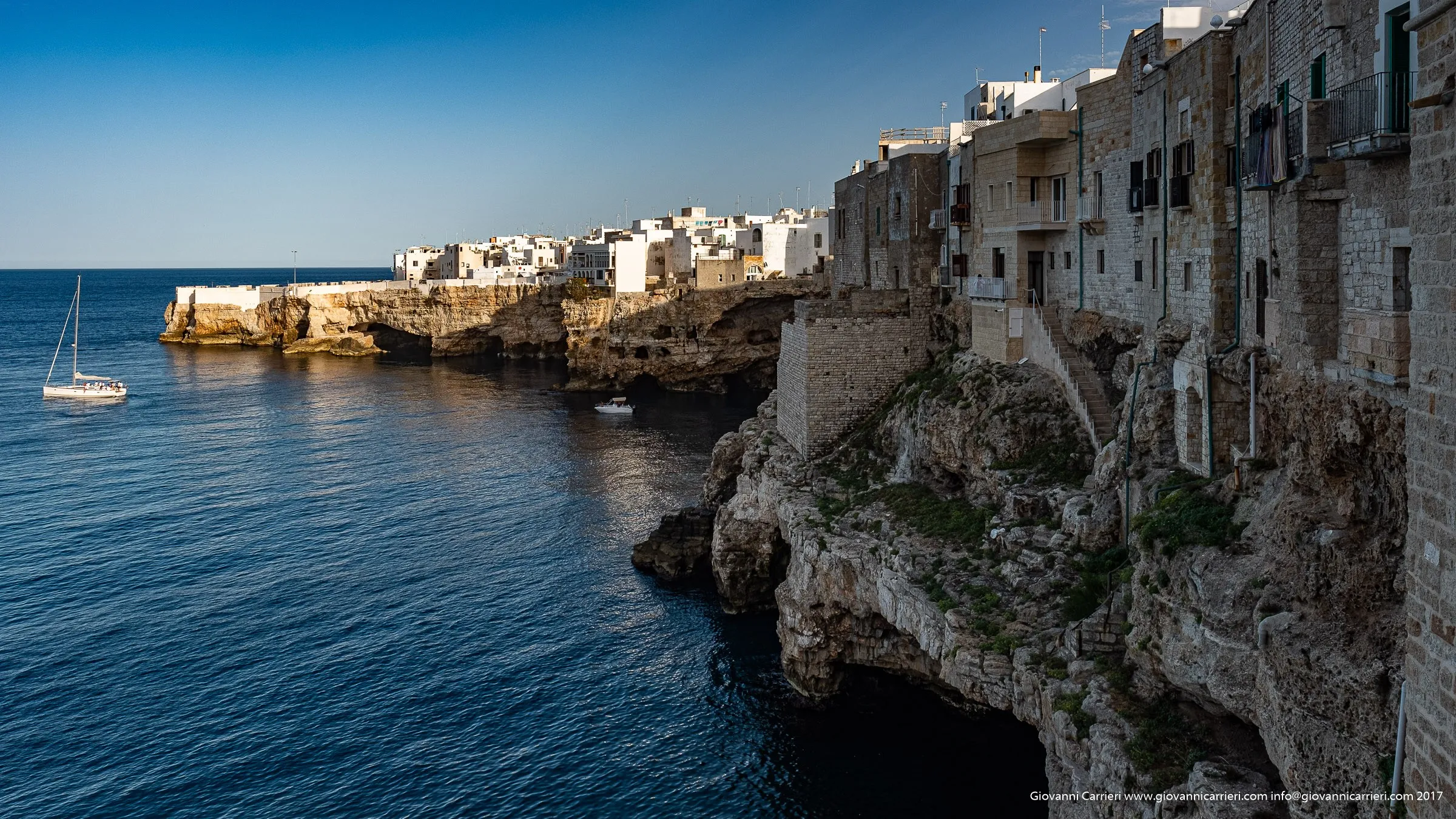 The cliffs and the blue water of Polignano a Mare