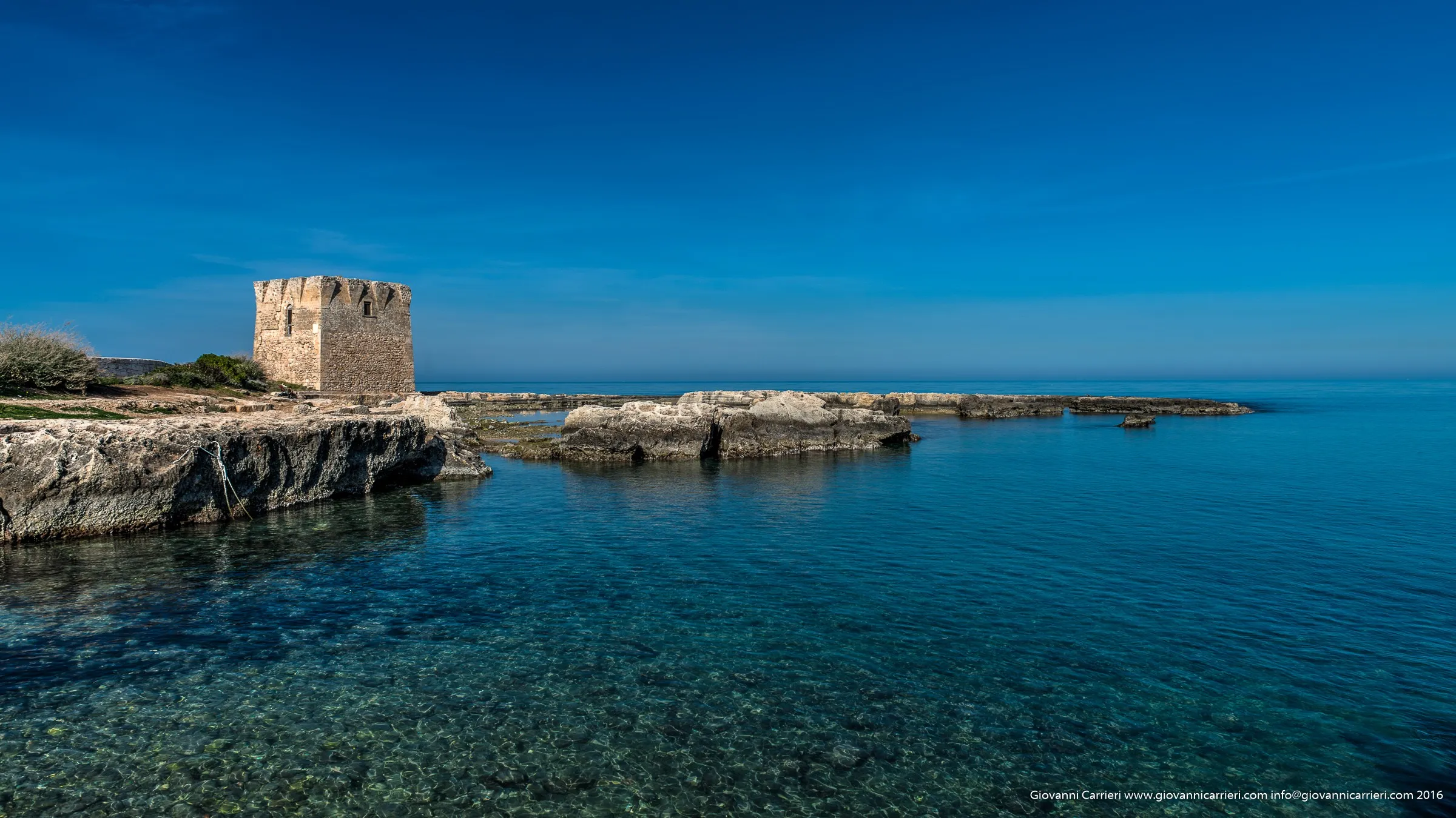 The San Vito tower and clear blue sea of Polignano a Mare