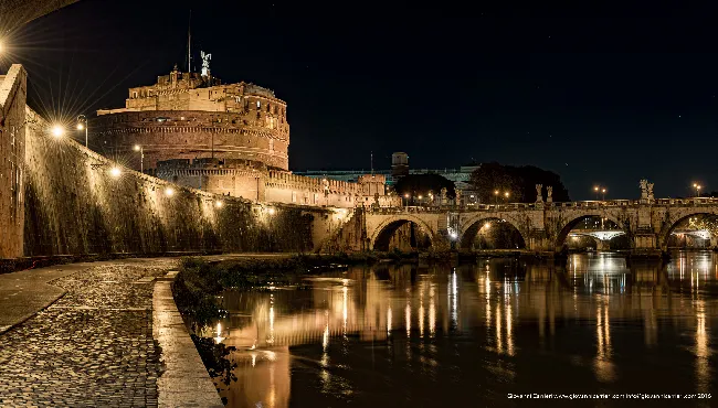 The sunset over Castel Sant'Angelo seen from river of Tevere