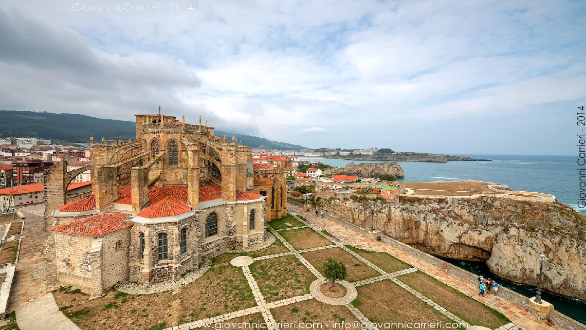 Panoramic view of the church of Santa Maria Assunta and the Bay of Biscay