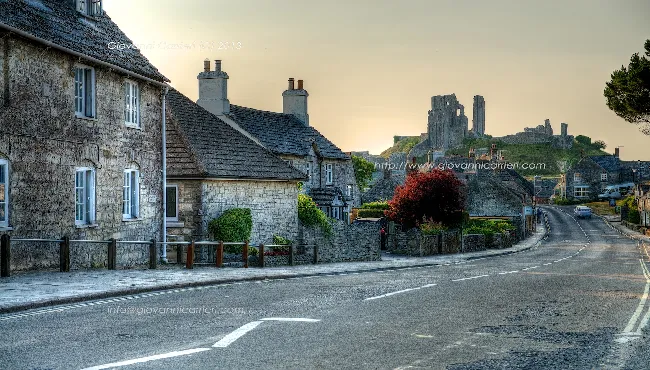 Corfe Castle village at sunset with the castle
