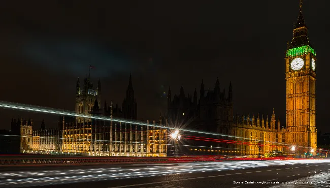 Houses of Parliament and Big Ben with night light trails