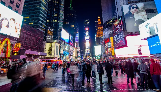 Times Square is a major commercial intersection and a neighborhood in Midtown Manhattan, New York City, at the junction of Broadway (now converted into a pedestrian plaza) and Seventh Avenue and stretching from West 42nd to West 47th Streets.