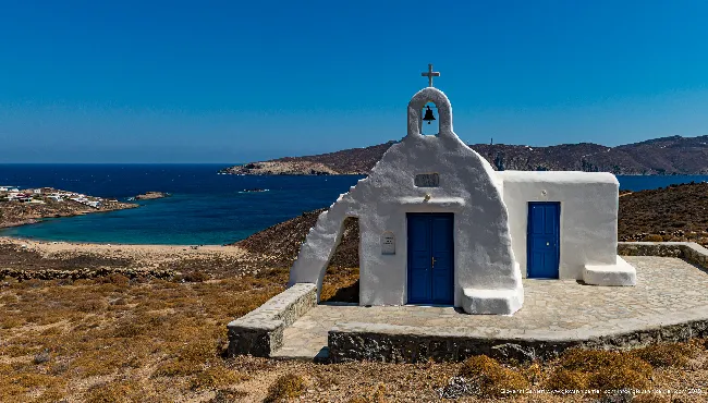 White chapel overlooking Mykonos bay