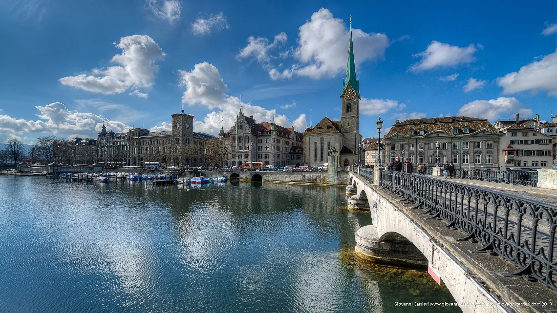 The clock tower of Fraumünster viewed from Limmat river